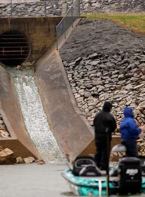 As the rain got heavier, water began to pour from a storm drain into Douglas Lake.