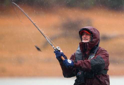 Mark Hicks makes a cast with a jig as the rain intensifies late in the morning.
