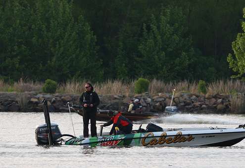 <p> </p> <p>Wendlandt places a fish in the live well, while Elite Series angler Keith Poche speeds past him in an aluminum boat he had chosen to use for this tournament. </p> 