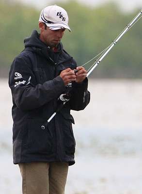 <p>Mike Iaconelli changes baits on his flipping stick. </p> 