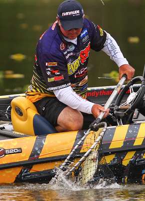 <p>Tharp secures the bass in the net.</p> 