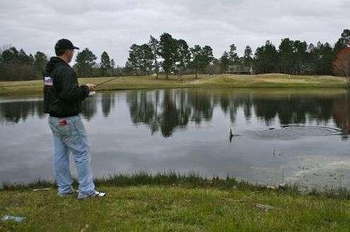 <p>With a blue tee marker behind him, Pace reels in another bass. That's his house, on the horizon, above the jumping fish. It's 215 yards from the blue marker to the flag pin on the other side of the pond. Pace, by the way, doesn't play golf. His passions for fishing and bow-hunting whitetail deer require most of his free time. Pace knew his competitive drive wouldn't allow for casual duffing, so he never took up the sport.</p>
