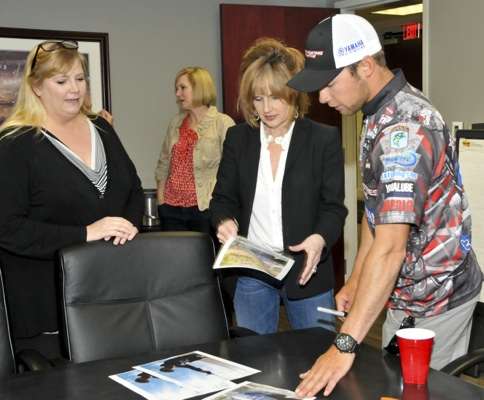 <p>Teresa Lux meets Brandon for an autograph. Cara Clark, our media Communications Manager looks on.</p>

