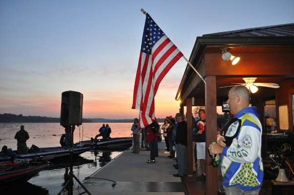 Anglers turn toward the flag for the singing of the national anthem.