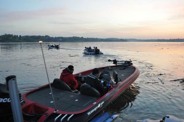 Amid surface debris, the first anglers in the lineup head out onto Douglas Lake.