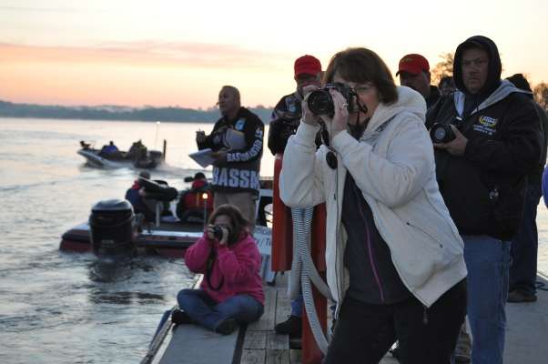 <p> </p>
<p>Family members take photos of their loved ones as they head out.</p>
