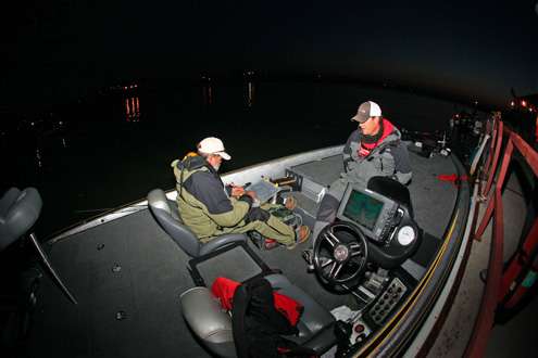 <p> </p>
<p>Co-angler Wayne Steiner preps his tackle as fifth-place angler Josh Bragg keeps warm in the predawn day at Douglas Lake. </p>
