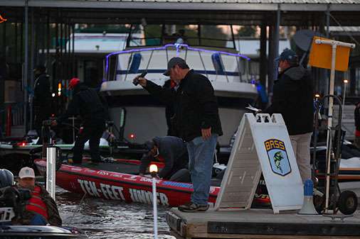 B.A.S.S. staffers perform safety checks as anglers idle their boats toward take-off.