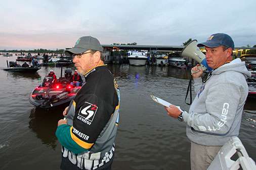<p>Tournament Director Chris Bowes (right) calls flight orders as anglers pass through inspection.</p> 