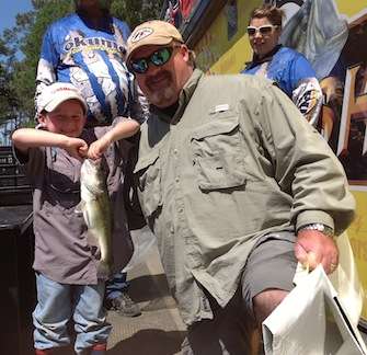 <p>Jackson Speaker shows off the bass he caught while fishing with his dad.</p>

