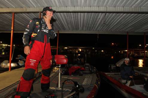Kevin VanDam is under the boat house talking on the phone.