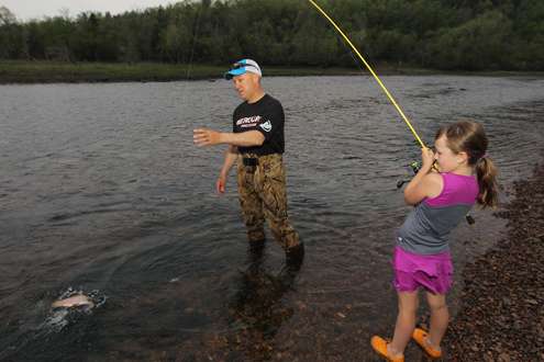 <p>It's Chapmanâs daughter's turn to catch a trout.</p>
