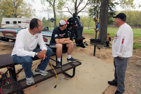 <p>James Niggemeyer, John Murray and Michael Simonton visit at a picnic table a few minutes before the heavy storms arrive.</p>
