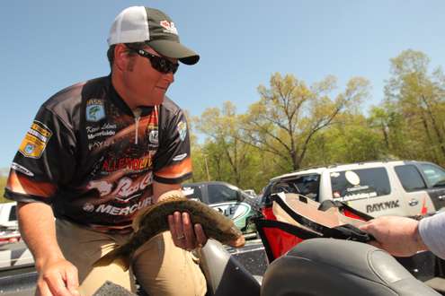 <p>Kevin Ledoux bags the small mouth bass he caught for Day One.</p>
