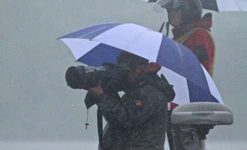 <p>Bassmaster photographer Seigo Saito captures the action under the protection of an umbrella.</p>
