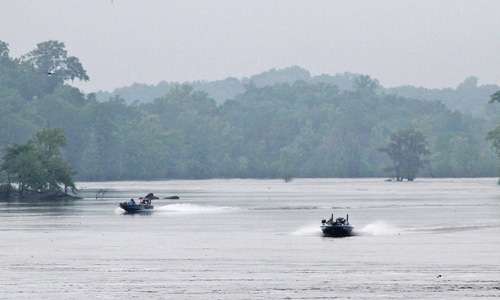 <p>Two boats run up the Coosa River Saturday morning. The boat to the right is Jared Miller and to the left is Day Two leader Brent Chapman. Both anglers fished the area the previous two days.</p>
