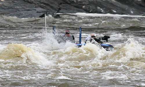<p>The choppy waves produce sprays of water as he crosses.</p>
