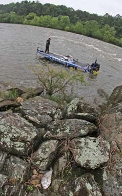 <p>On the opposite side, Miller fishes an eddy on the back side of a rock point. A dead drum indicates how far the river has fallen.</p>
