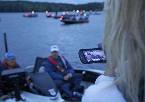 <p> </p>
<p>A blonde-haired fan focuses her camera on the anglers as they pass the dock.</p>
