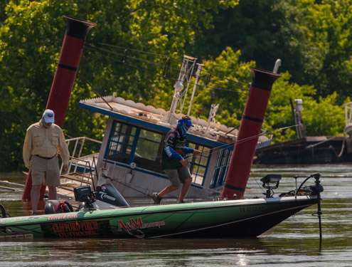 <p>Cliff Pirch makes his way to the trolling motor as he secured a new bait.  The current is taking control of his rig.</p>
