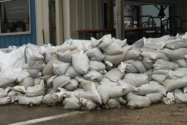 <p>Sand bags piled high to prevent the rising water from entering this store. </p>
