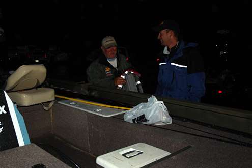<p> </p>
<p>Ott DeFoe converses with his co-angler while they prep his aluminum bass boat.</p>
