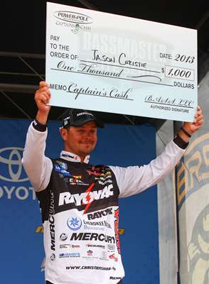 <p>Prize money is usually distributed at weigh-ins for awards earned in the most recent Elite Series tournament, so Day Two was payday for four pros who claimed five prizes. Above, Jason Christie picks up $1,000 at Bull Shoals from Power Pole.</p>
