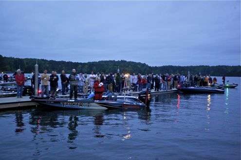 <p> </p>
<p>Anglers and observers stand at attention during the National Anthem.</p>
