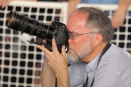 <p>A local photographer covers an event.</p>
