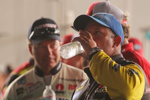 <p>After another hot day of fishing, Bobby Lane drinks water as he lines up for the weigh-in.</p>

