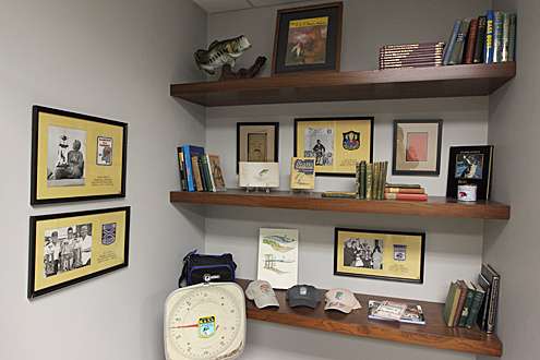 <p>More B.A.S.S. memorabilia is on display including vintage magazine covers, hats and an old set of tournament scales.</p>
