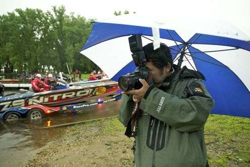 <p>Photographer Seigo Seito used the protection of an umbrella to shoot photos and keep his camera dry.</p>
