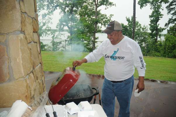 <p>Al Guzman of Livingston Lures gets the grill ready so he can hand out free hot dogs to the crowd.</p>
