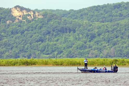 <p>Takahiro Omori fishes in sight of one of the tall bluffs that line the main river channel. </p>
