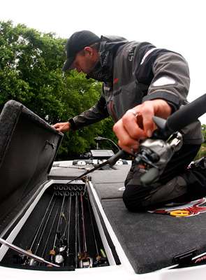 <p>Martens dives into his well-organized storage space for a new rod.</p>
