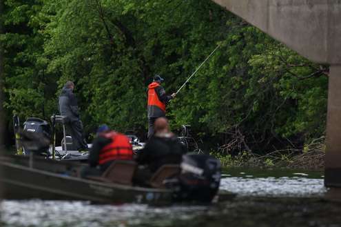 <p>Bobby Lane works the shoreline as a couple of local anglers motor up to get a closer look. Lane had 25 pounds, 14 ounces for 18th place after Day Three.</p>
