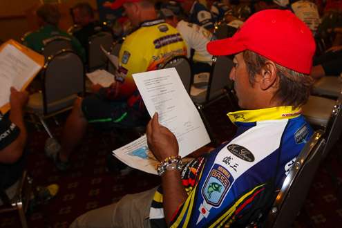 <p>Morizo Shimizu takes time to read up on the rules and regulations prior to the meeting.</p>
