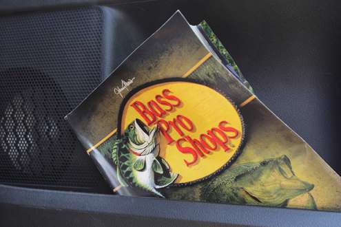 <p>A Bass Pro Shops catalog is in his door pocket. </p>

