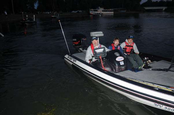 <p>West Virginia juniors Henry Schomaker and John Burkley with boat captain Ken Hackworth.</p>

