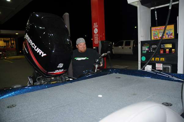<p>Keith Gowan adds some fuel to his boat.</p>

