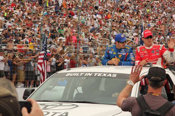 <p>Martin Truex Jr. takes a lap in a Texas-built Toyota Tundra with fellow driver Kevin Harvick during pre-race introductions. </p>
