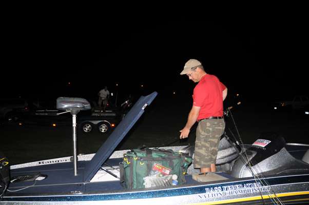 Brady Farrell loads his rods into his partnerâs boat.
