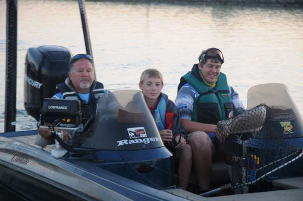 South Dakota juniors Trey Doom and Zachary Brown with boat captain Allan Hall.