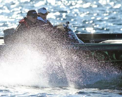 <p>Jonathon VanDam picks up and moves upstream, sending a spray of water highlighted by the sun.</p>
