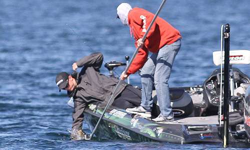 <p>Nearby, Jonathon VanDam brings a keeper to the side of the boat while Bassmaster cameraman, Wes Miller, captures the action on a GoPro.</p>

