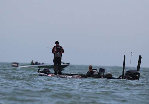 <p>Grant Goldbeck focuses on his electronics while a spectator boat idles by.</p>
