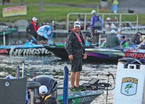 <p>Fred Roumbanis jokes with another angler as he gets his boat in position to start.</p>
