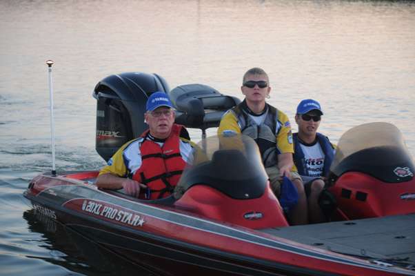 Michigan juniors Chase Serafin and David Aukema with boat captain Paul Wagner.
