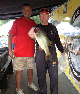 Mike Cox with Zeko Shoes shows off his catch with weigh master Mike Wheatley.