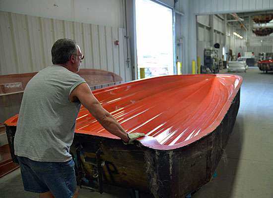 <p>A mold containing the hull of a Triton 21HP is wheeled to the paint room. This is the top side of the bottom of the boat.</p> 